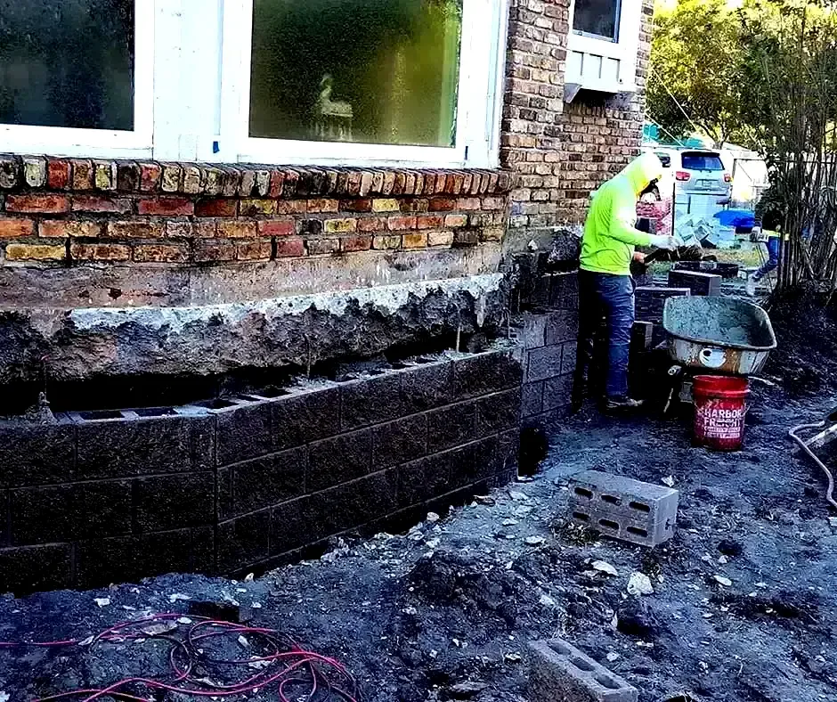 Worker rebuilding Foundation Repair Boston, MA